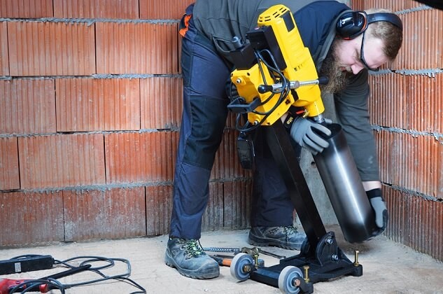 Mężczyzna pracujący przy wykorzystaniu wiertnicy na statywie poziomym WABROTECH